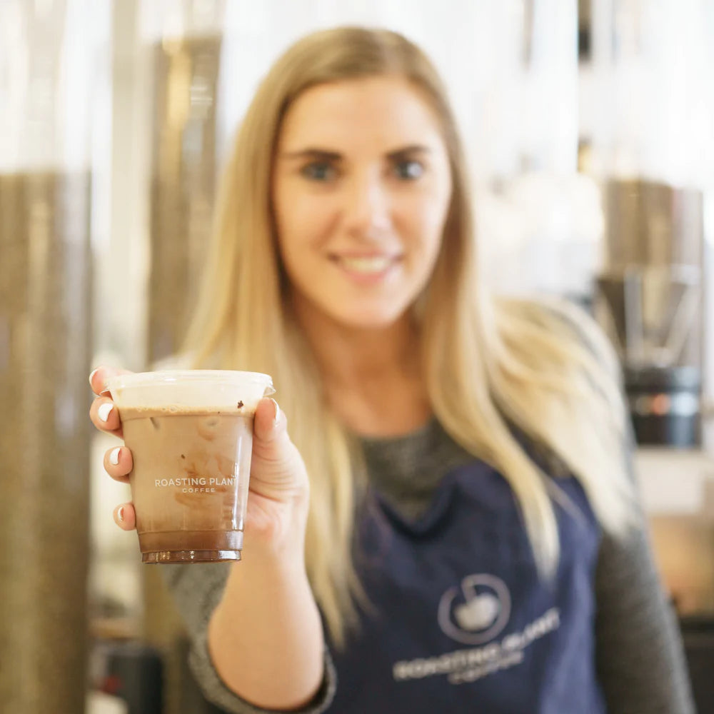 Woman holding up coffee drink